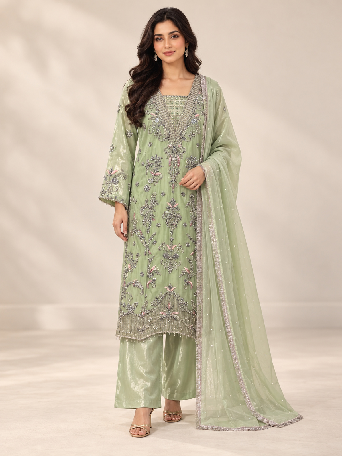 A light green ensemble with silver-toned floral embroidery, a patterned neckline and matching trousers.