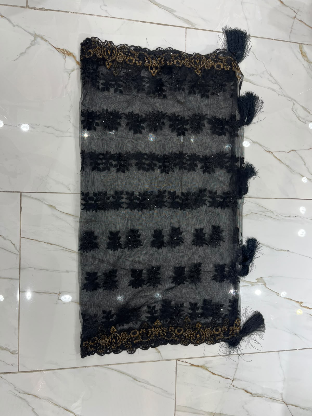 A black ensemble with multicolour floral embroidery, ornate…