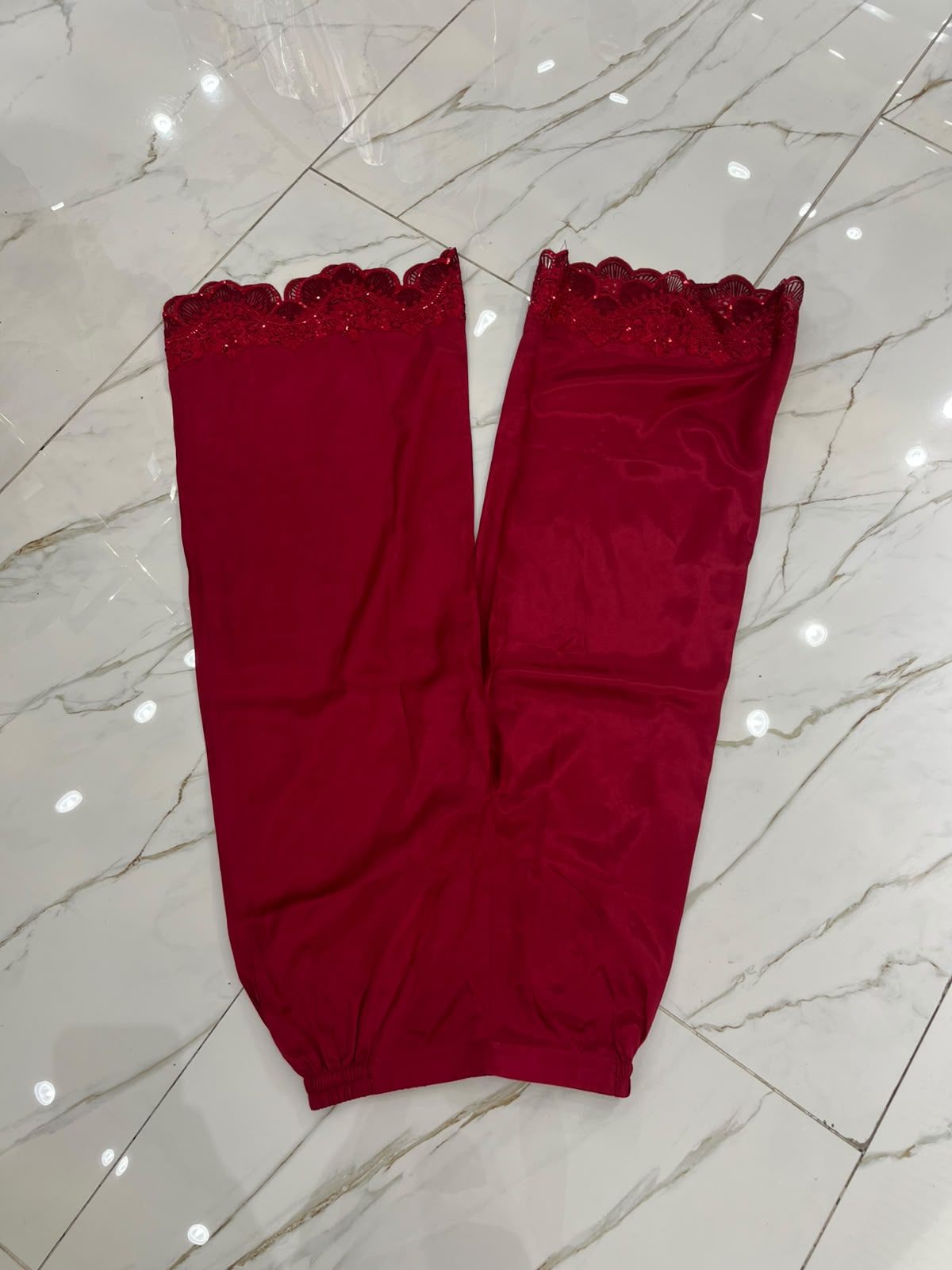 A deep red ensemble with tonal floral embroidery, sheer sleeve…