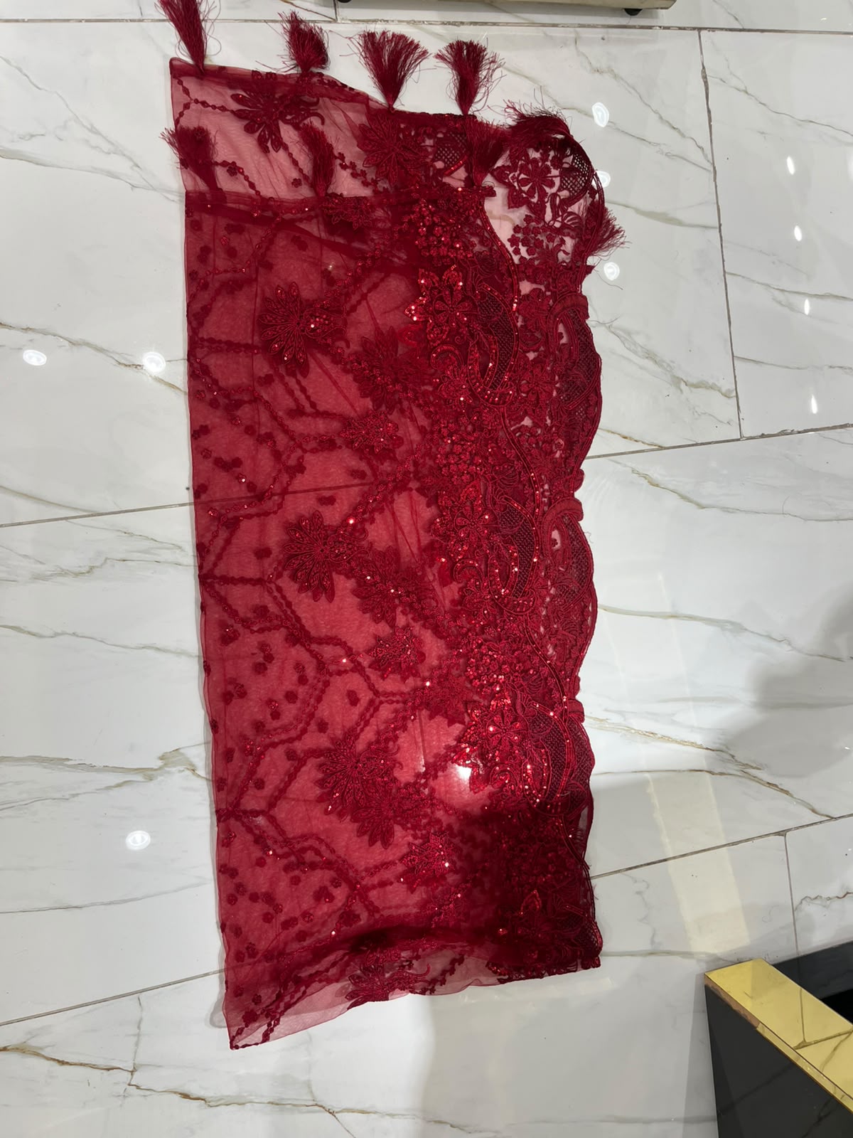 A deep red ensemble with tonal floral embroidery, sheer sleeve…