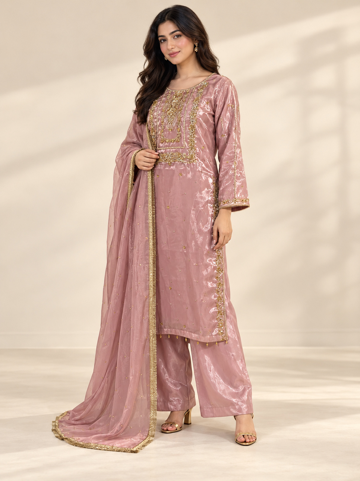 A rose pink ensemble with a rectangular embroidered chest panel and…