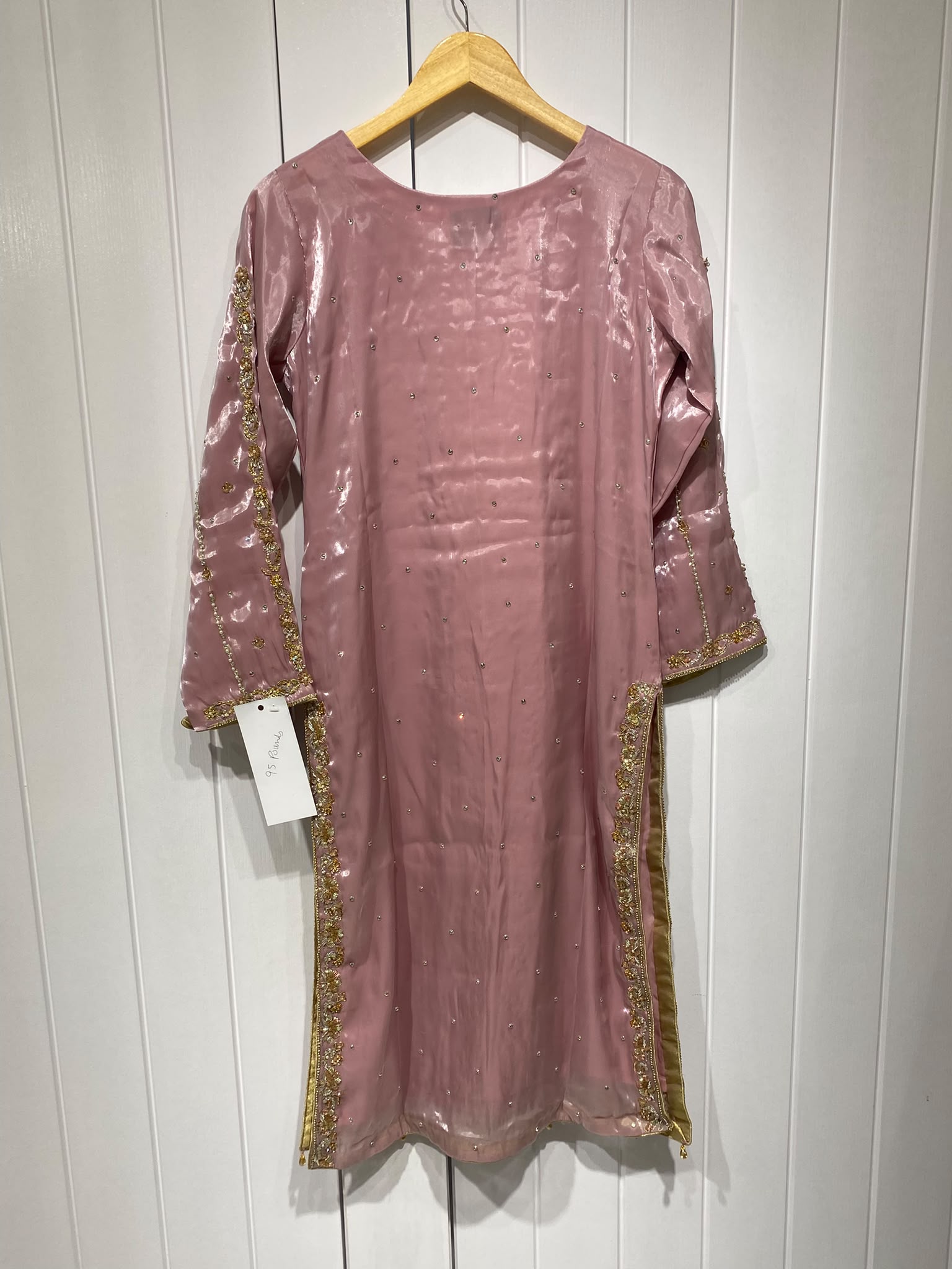 A rose pink ensemble with a rectangular embroidered chest panel and…