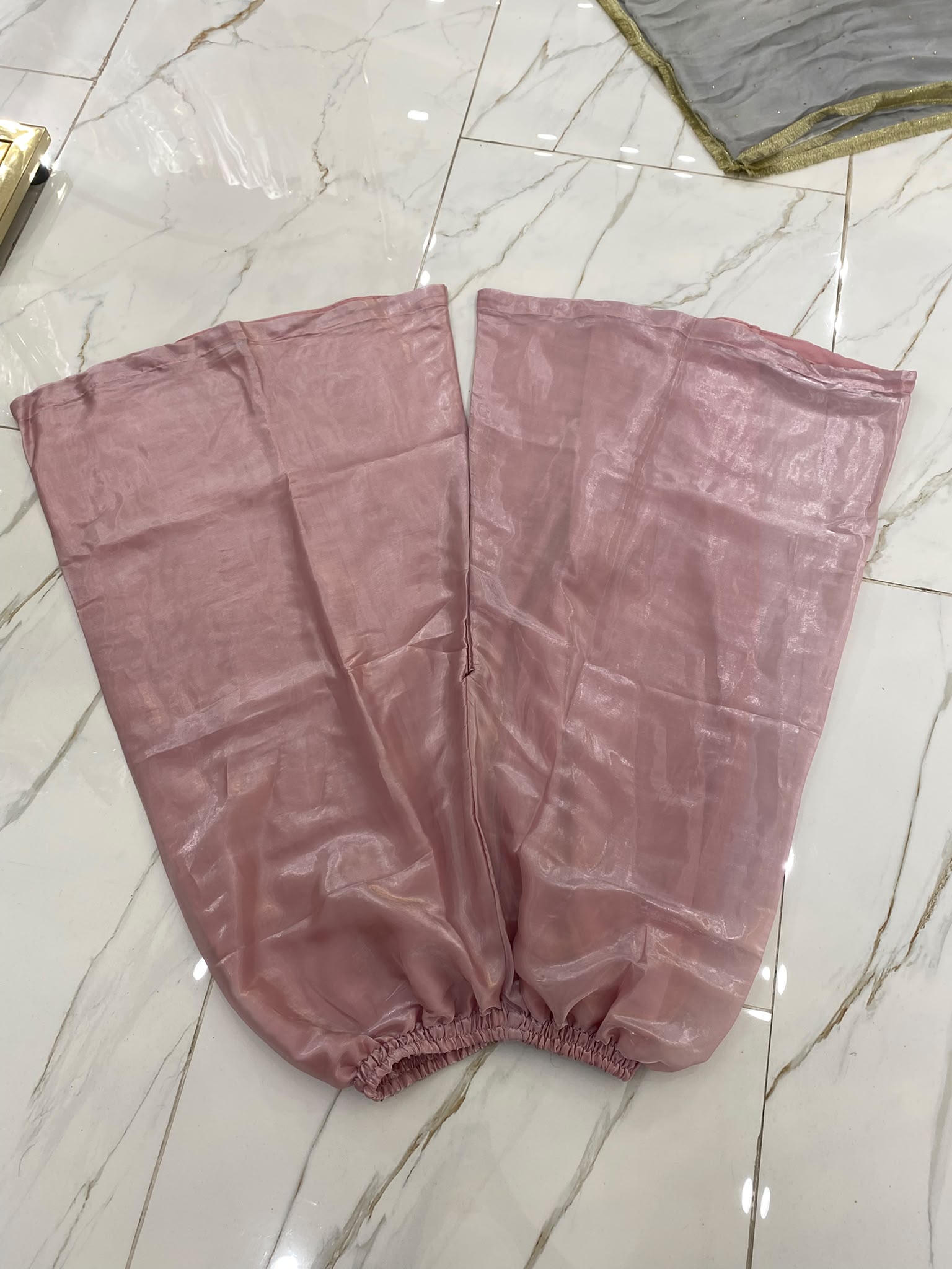 A rose pink ensemble with a rectangular embroidered chest panel and…