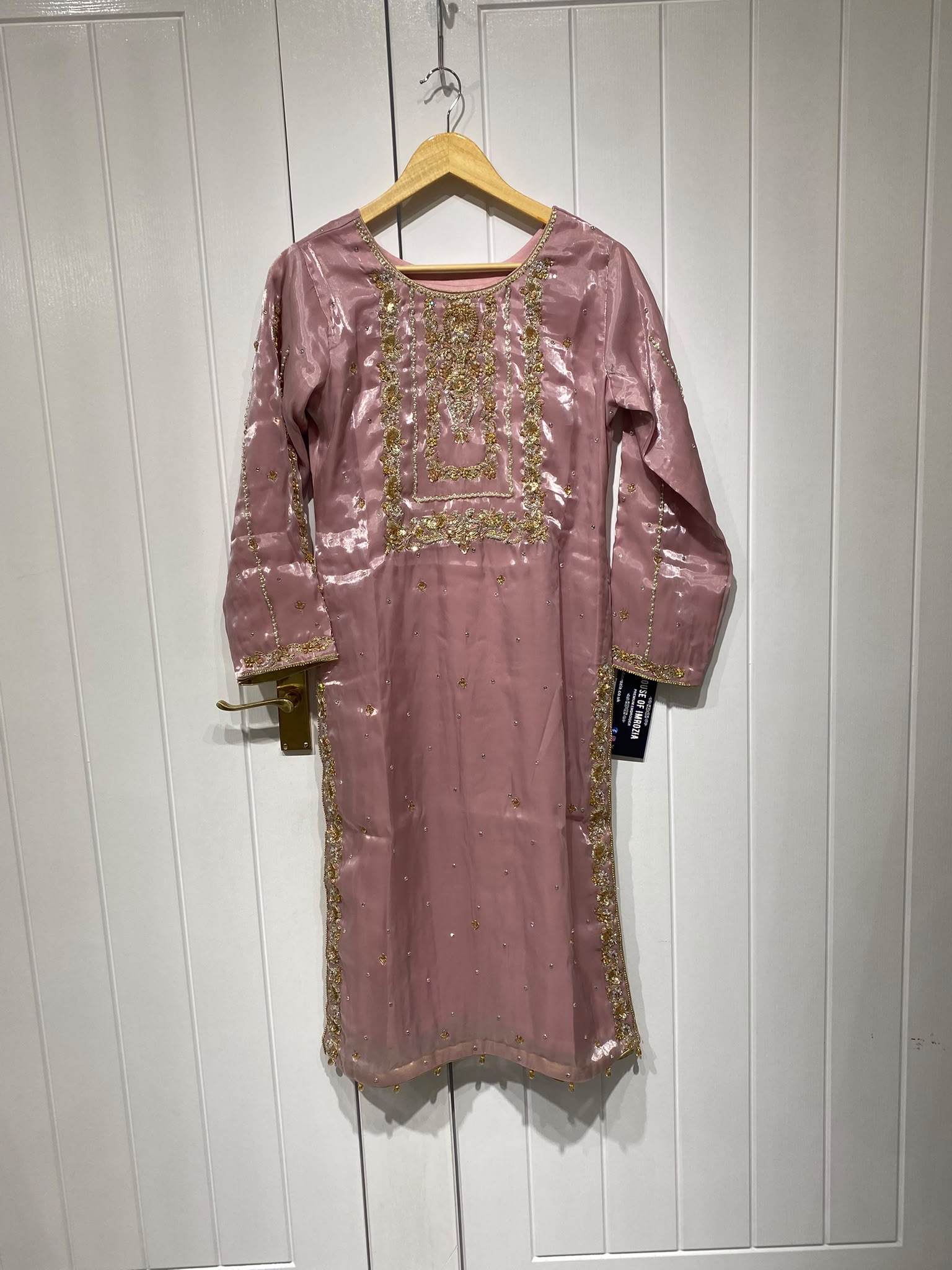 A rose pink ensemble with a rectangular embroidered chest panel and…