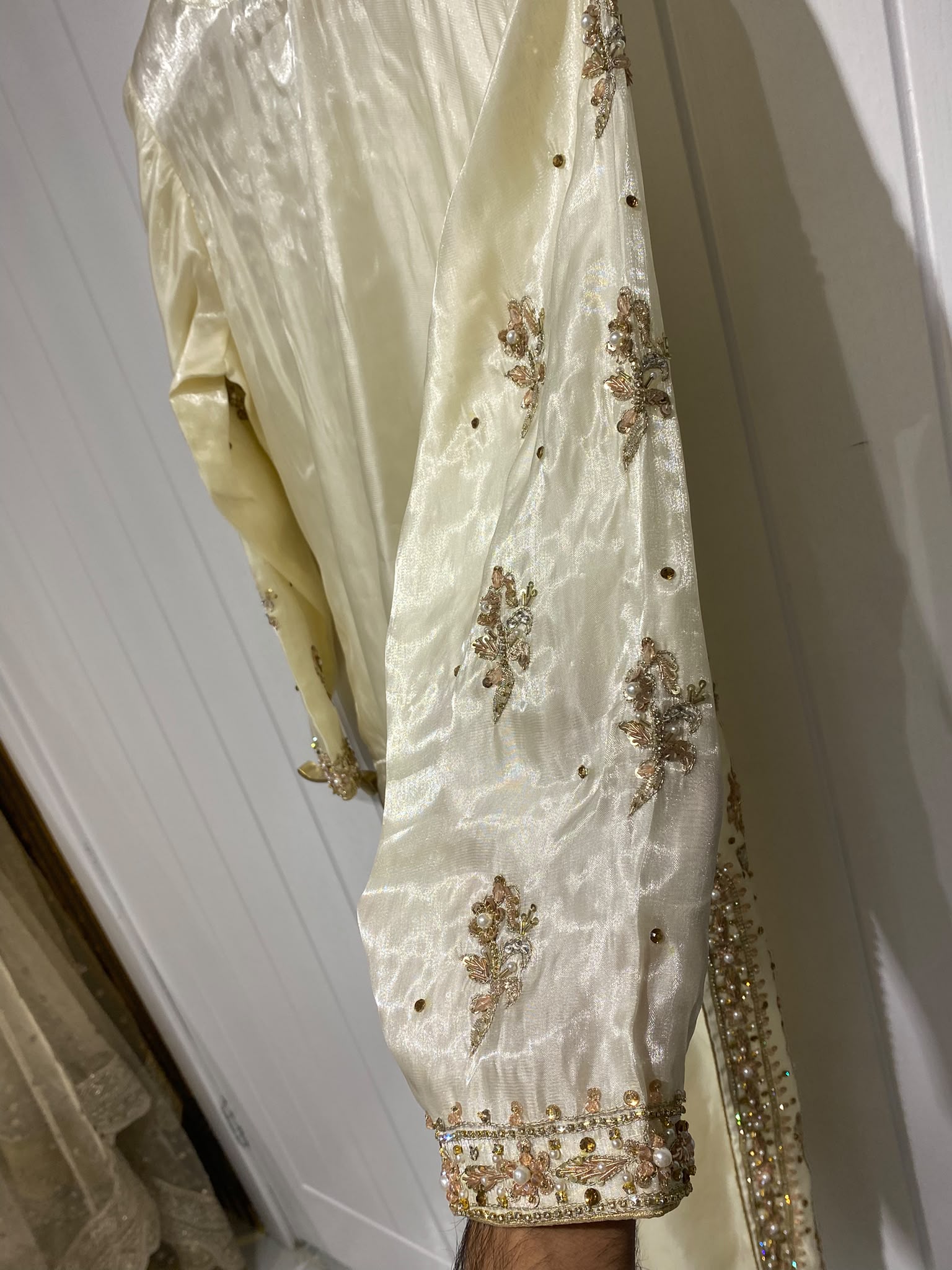A pale yellow ensemble with dense gold-toned floral panels…