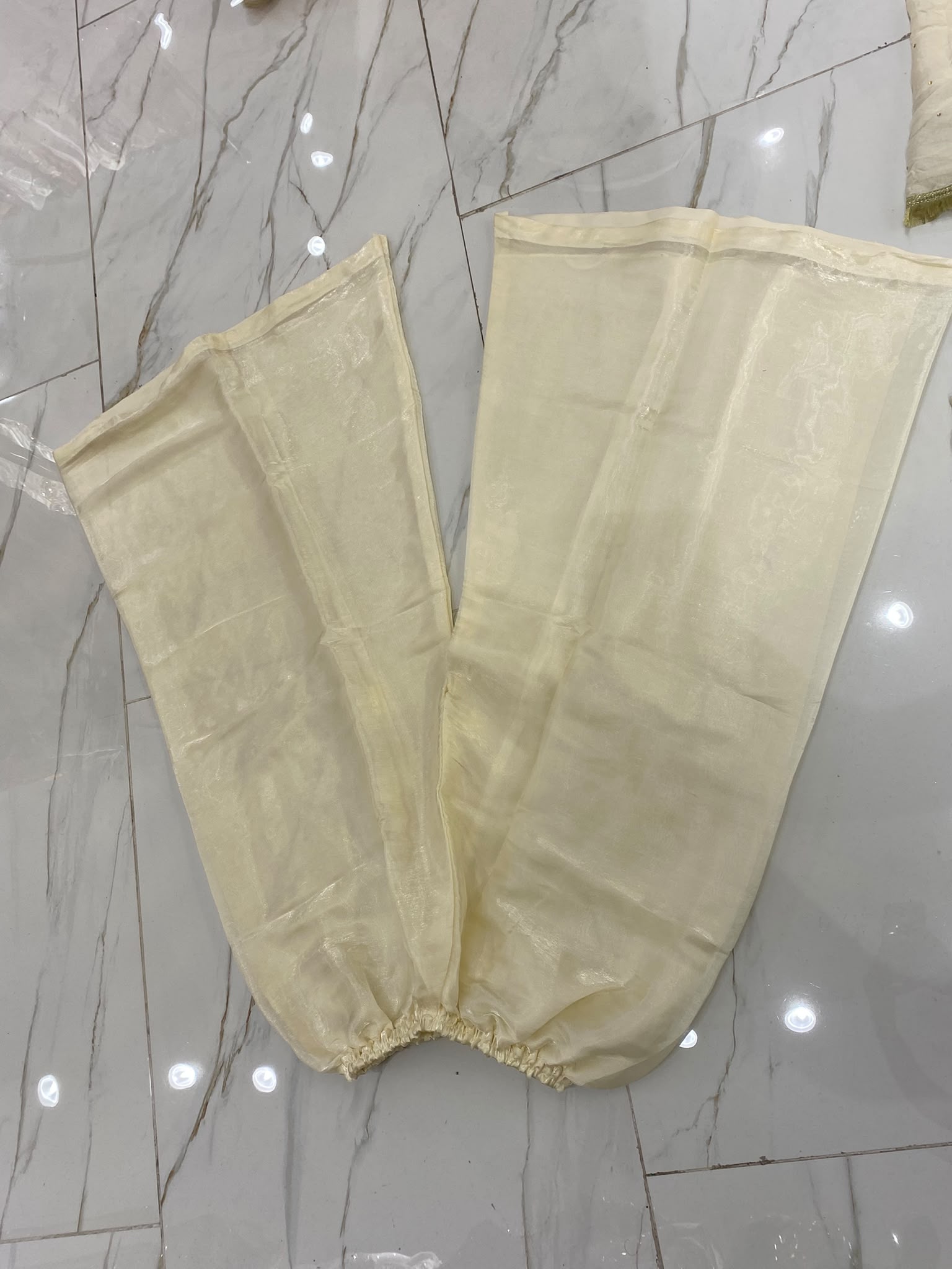A pale yellow ensemble with dense gold-toned floral panels…