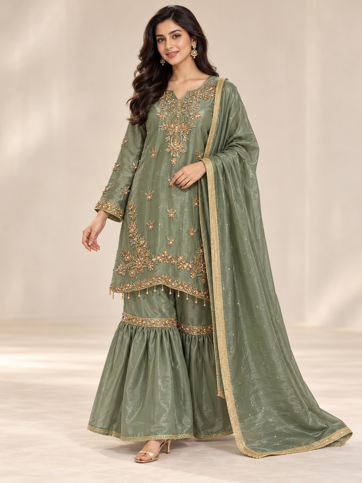 A sage green ensemble with a floral embroidered neckline, ornate…