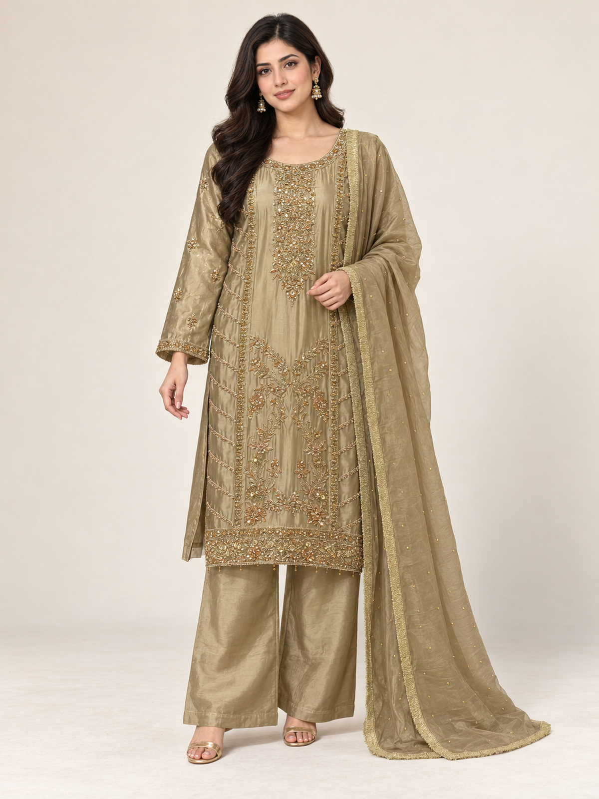 An olive gold ensemble with an elongated embroidered neckline, ornate…
