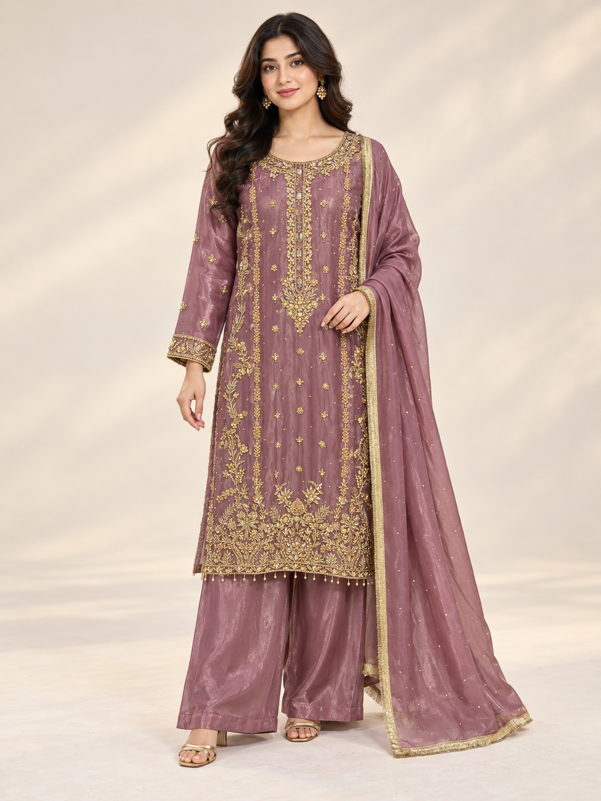 A mauve ensemble with elongated gold-toned neckline embroidery…