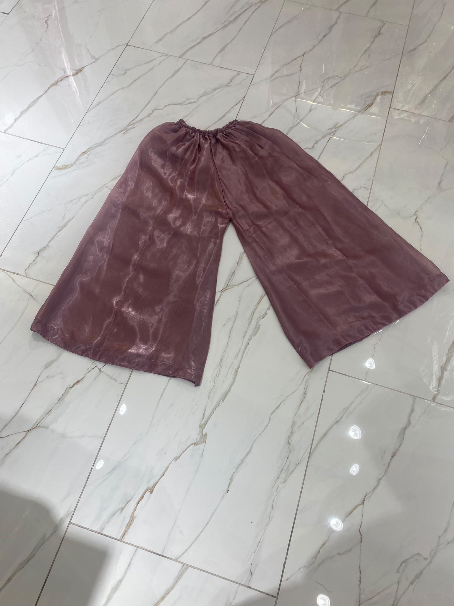 A mauve ensemble with elongated gold-toned neckline embroidery…