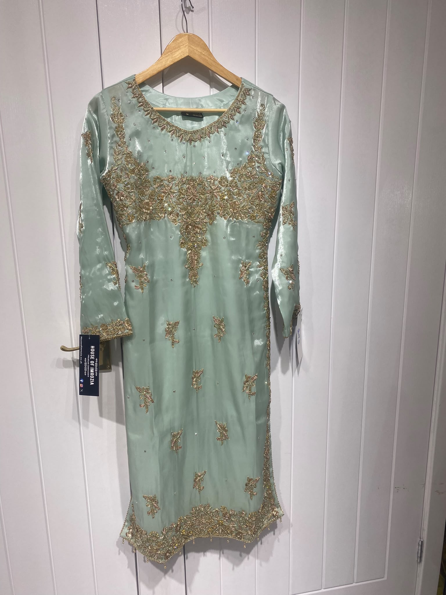 An aqua mint ensemble with a wide embroidered floral yoke, scattered…