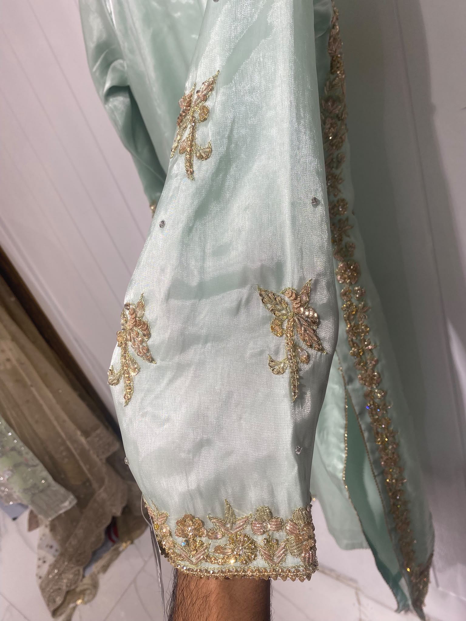 An aqua mint ensemble with a wide embroidered floral yoke, scattered…