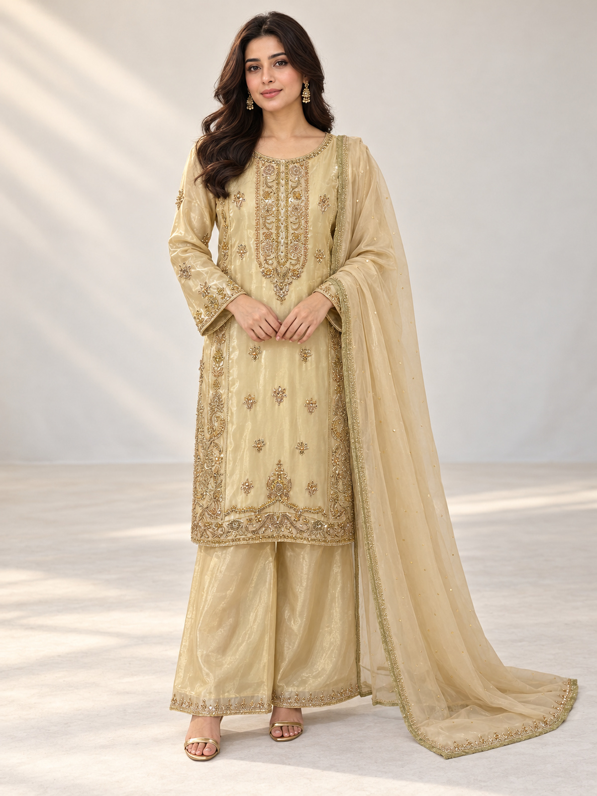 A champagne gold ensemble with an ornate embroidered neckline…