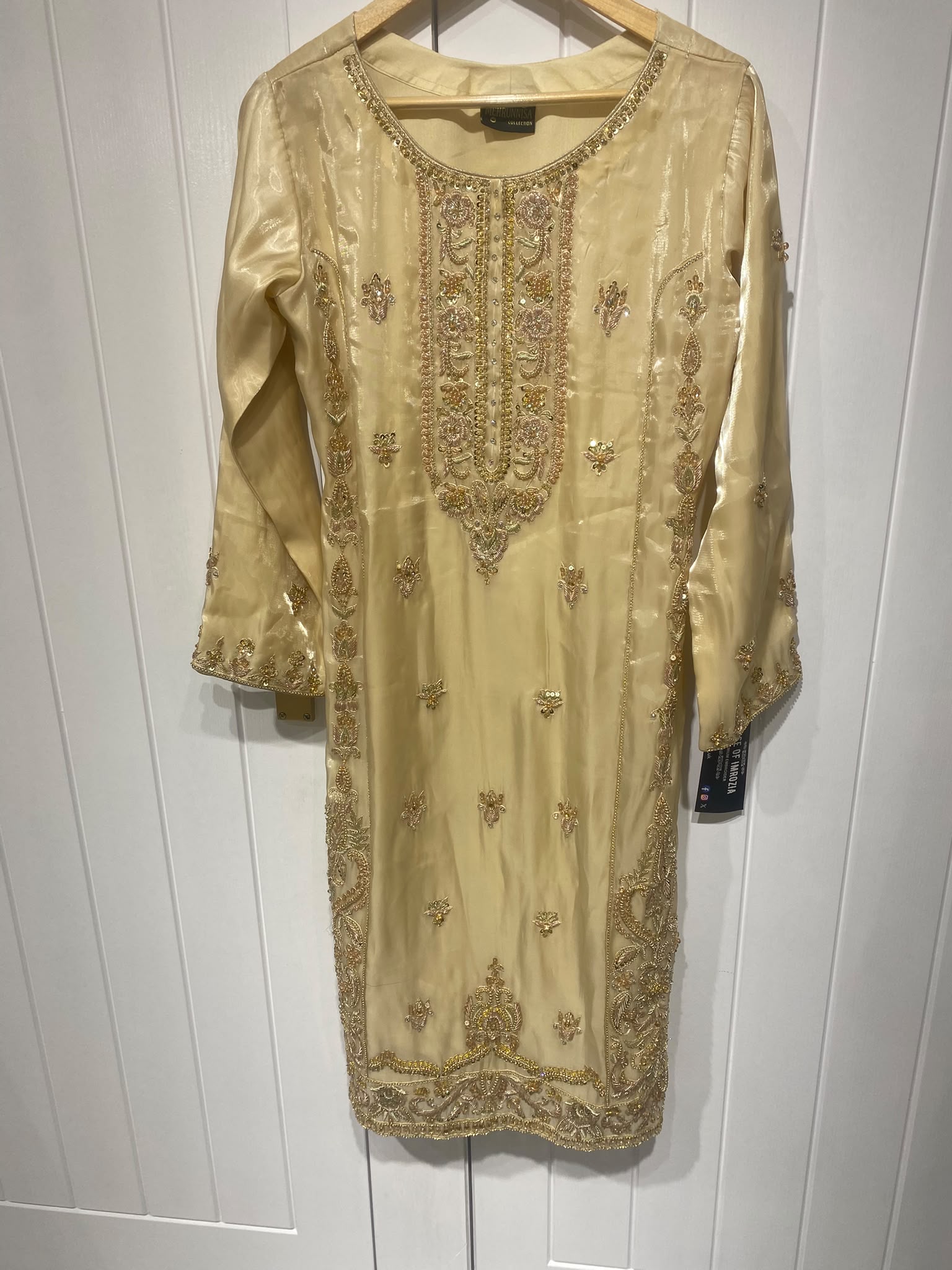 A champagne gold ensemble with an ornate embroidered neckline…