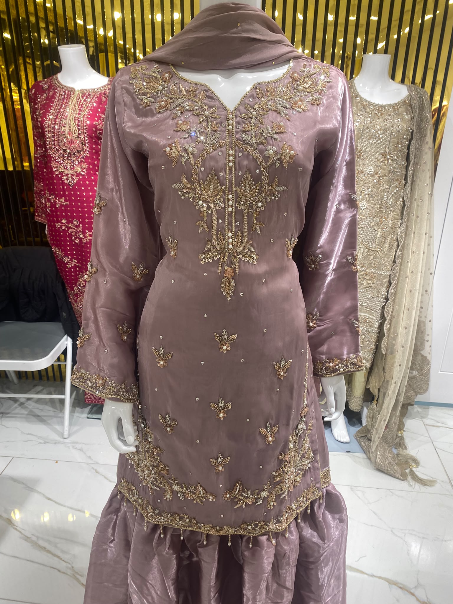A dusty mauve ensemble with floral neckline embroidery, tiered…