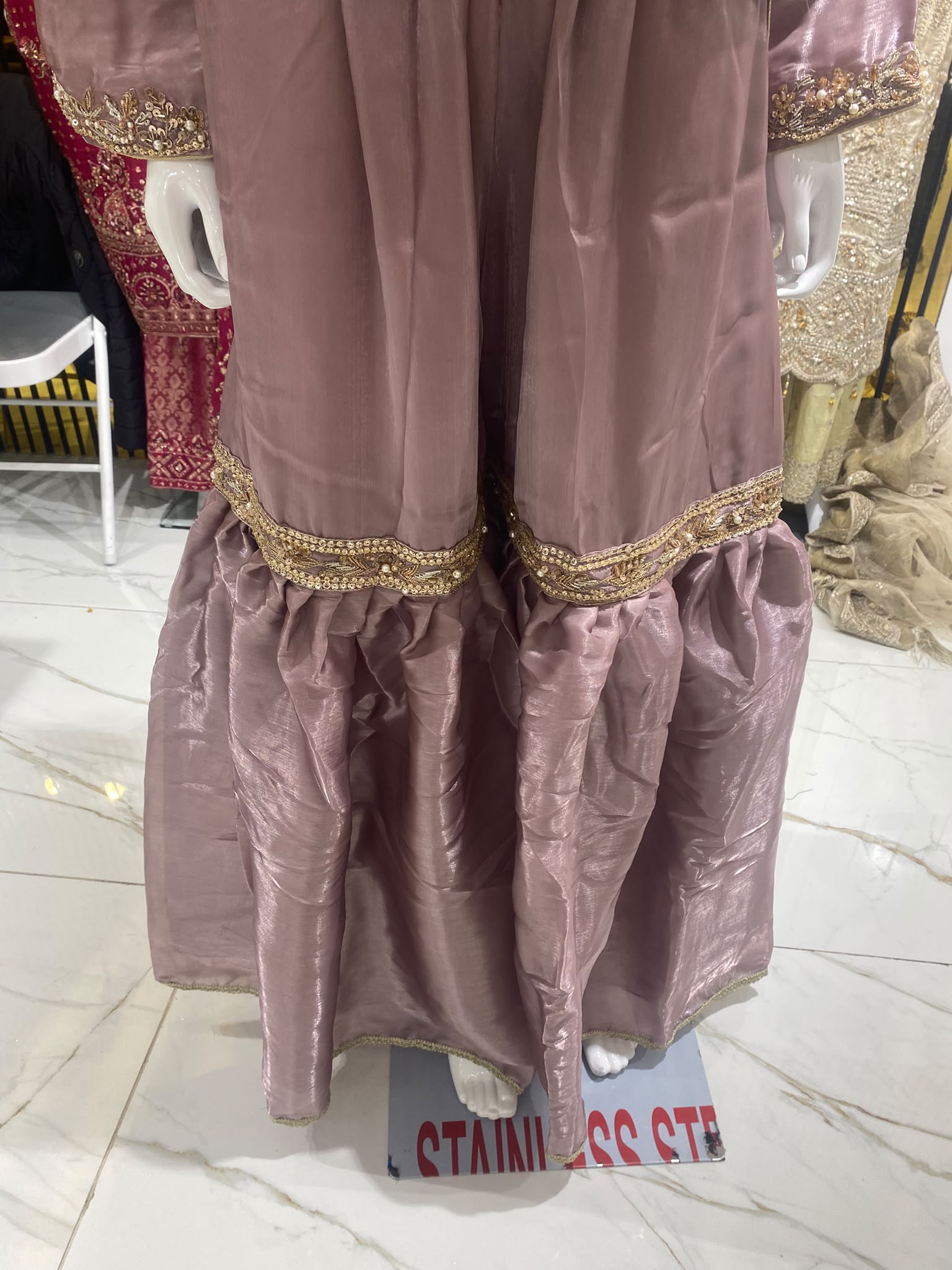 A dusty mauve ensemble with floral neckline embroidery, tiered…