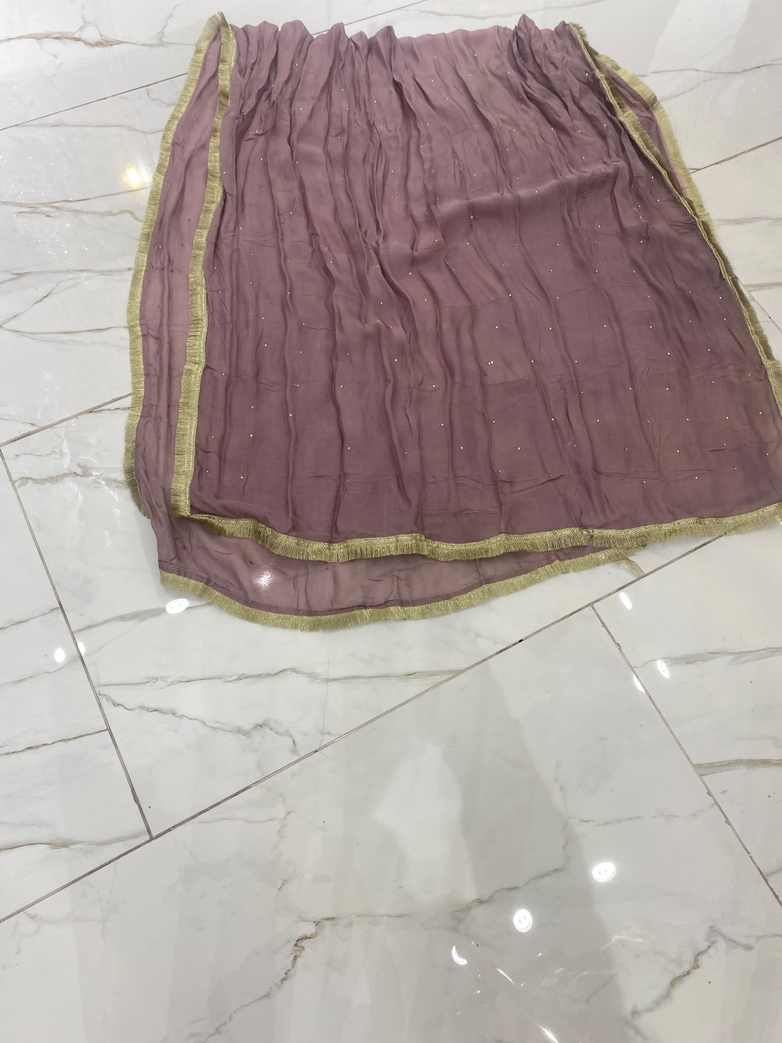 A dusty mauve ensemble with floral neckline embroidery, tiered…