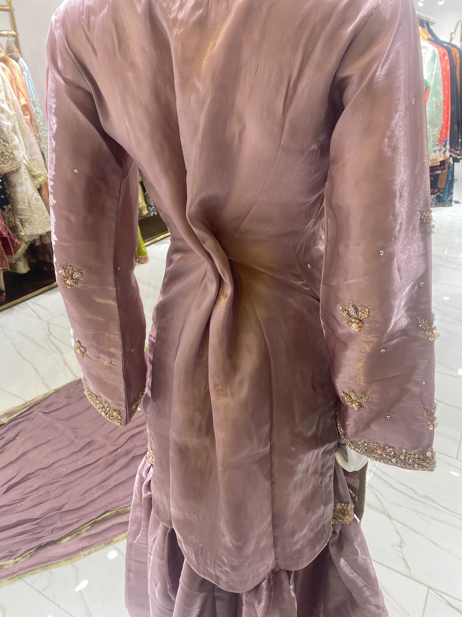 A dusty mauve ensemble with floral neckline embroidery, tiered…