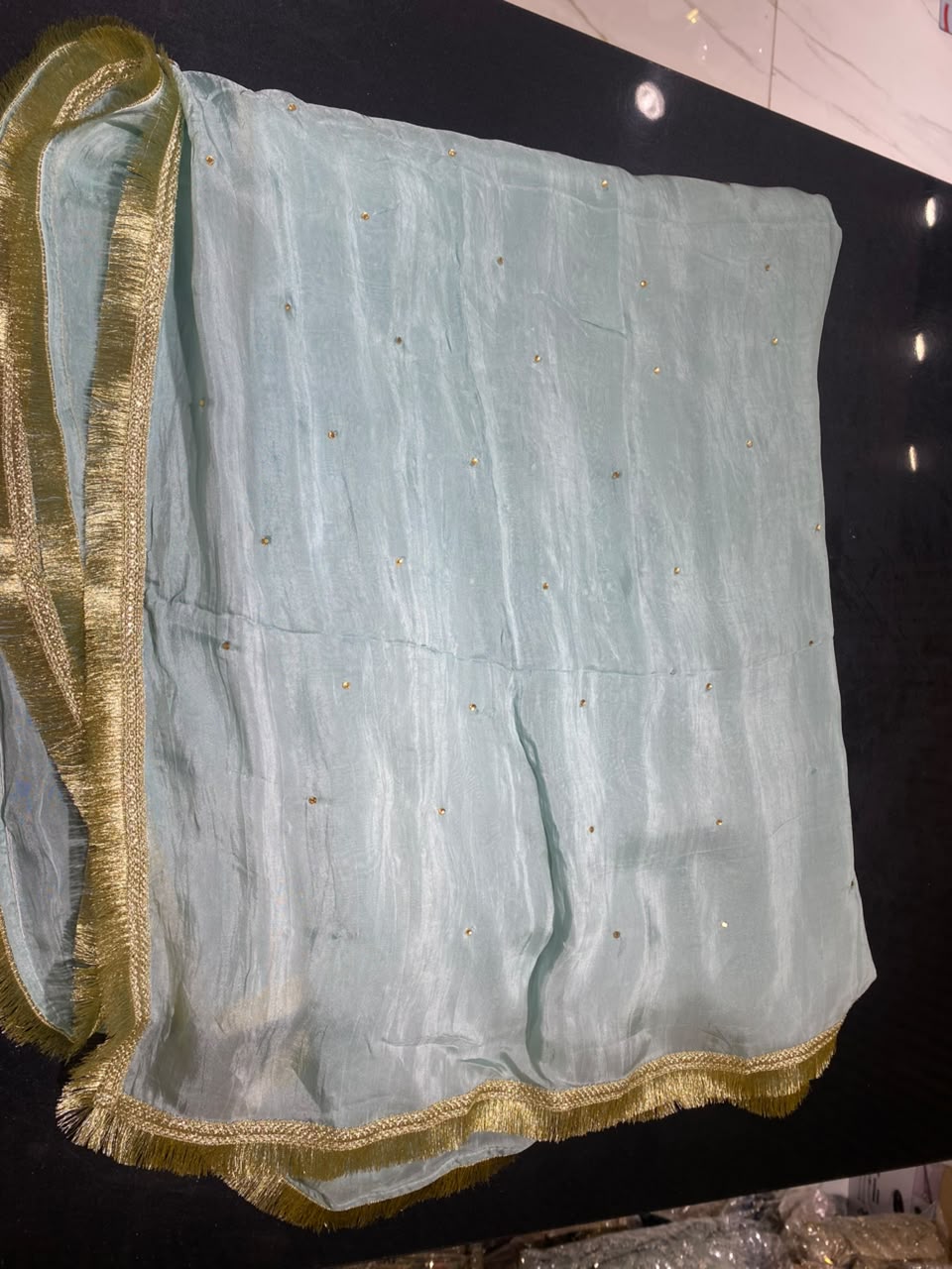 A lustrous aqua blue shirt with ornate gold-toned embroidery…