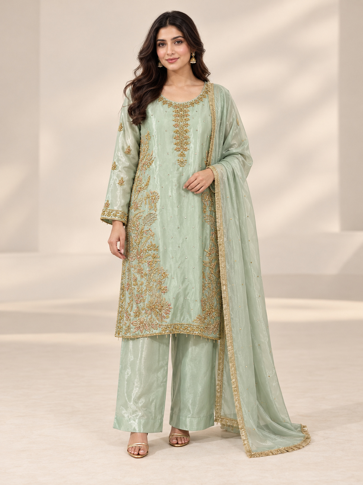 A pale mint ensemble with a decorative neckline, long embroidered…
