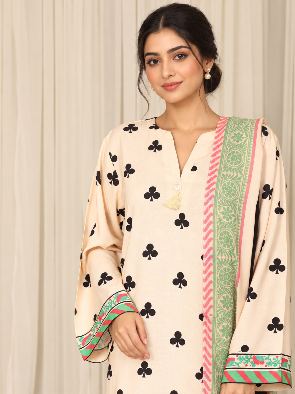 An ivory shirt patterned with black club-shaped motifs, striped…