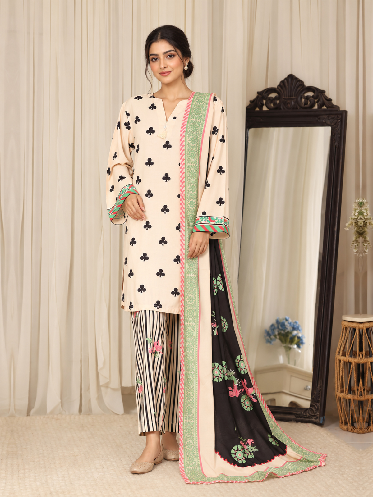 An ivory shirt patterned with black club-shaped motifs, striped…