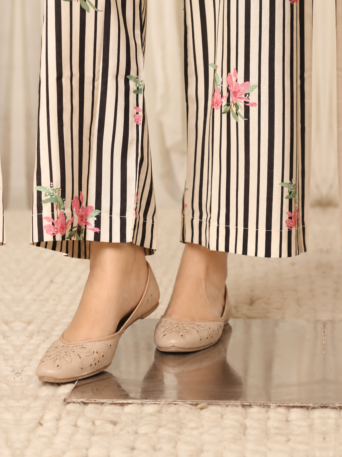 An ivory shirt patterned with black club-shaped motifs, striped…