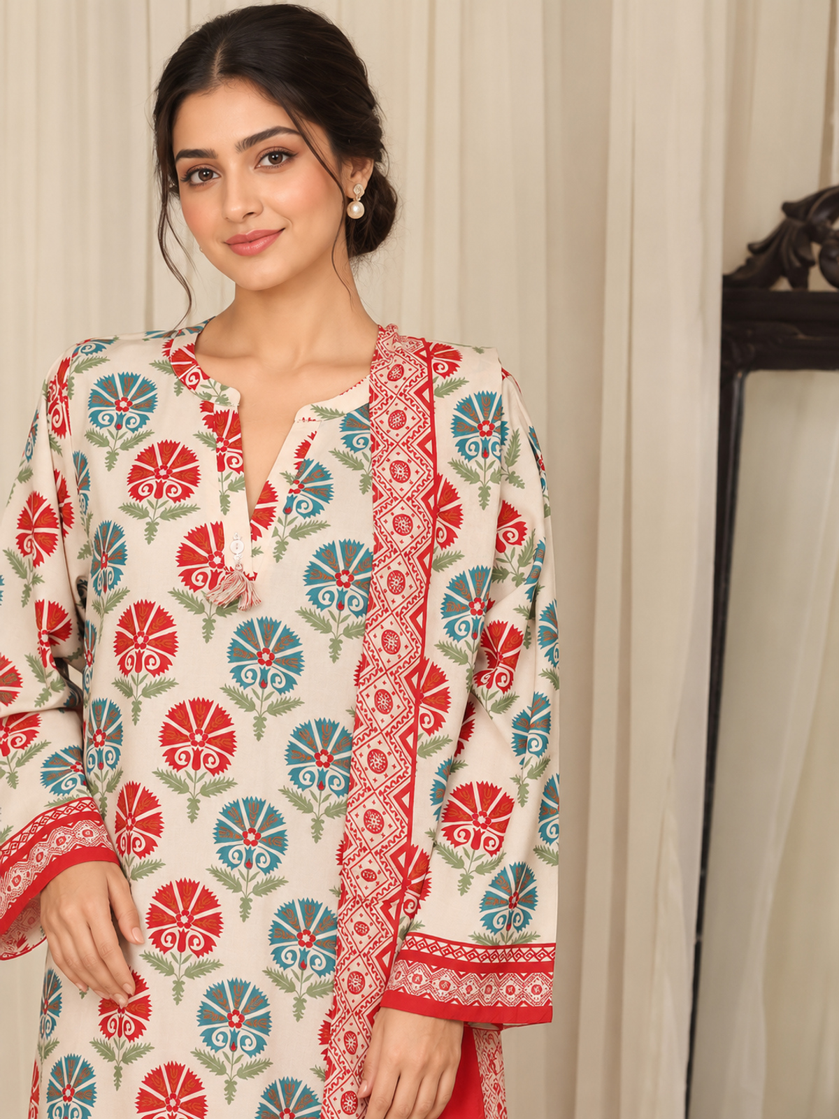 An ivory shirt with red and green ornamental motifs, red patterned…