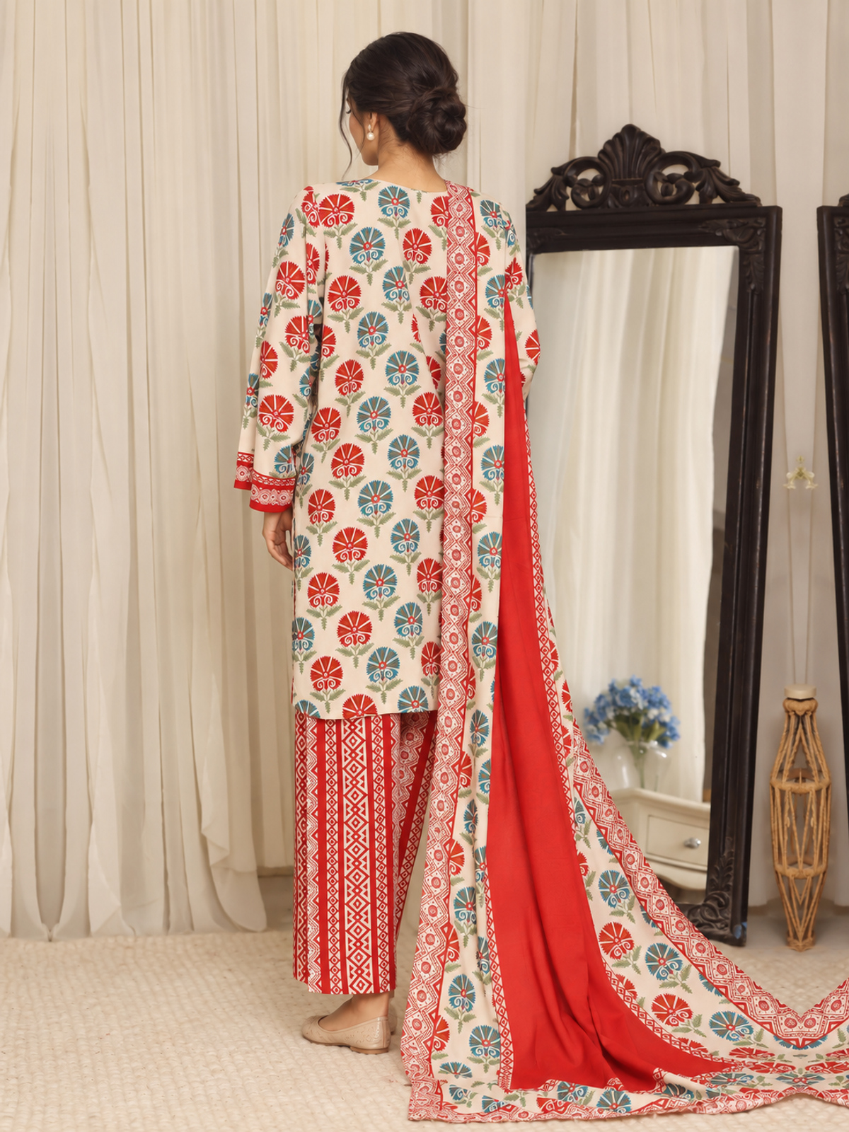 An ivory shirt with red and green ornamental motifs, red patterned…