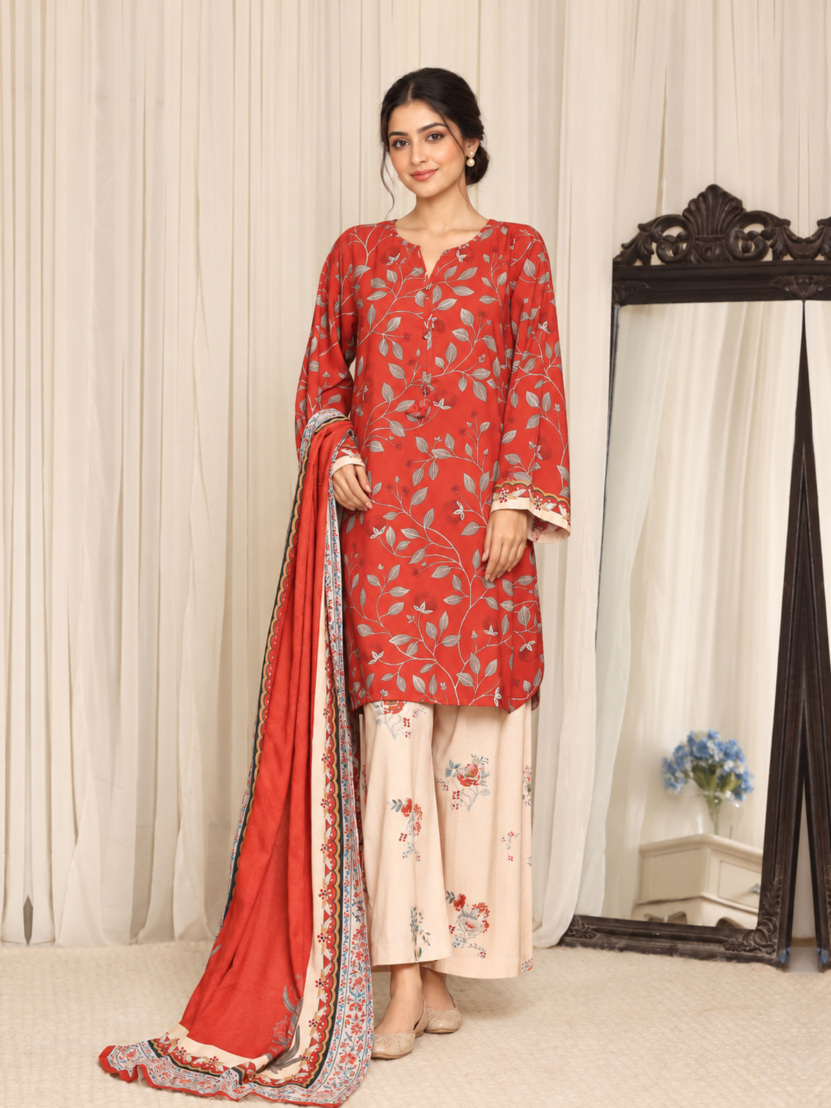 A red shirt covered with pale botanical motifs, teamed with cream…