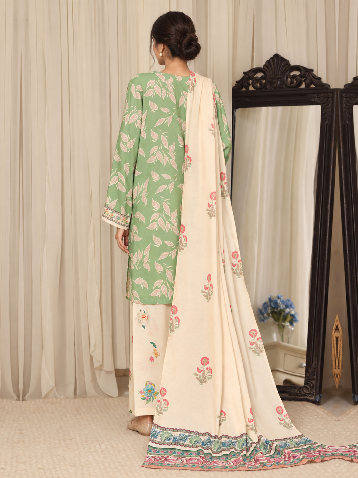 A sage-green shirt with pale botanical motifs, cream floral trousers…