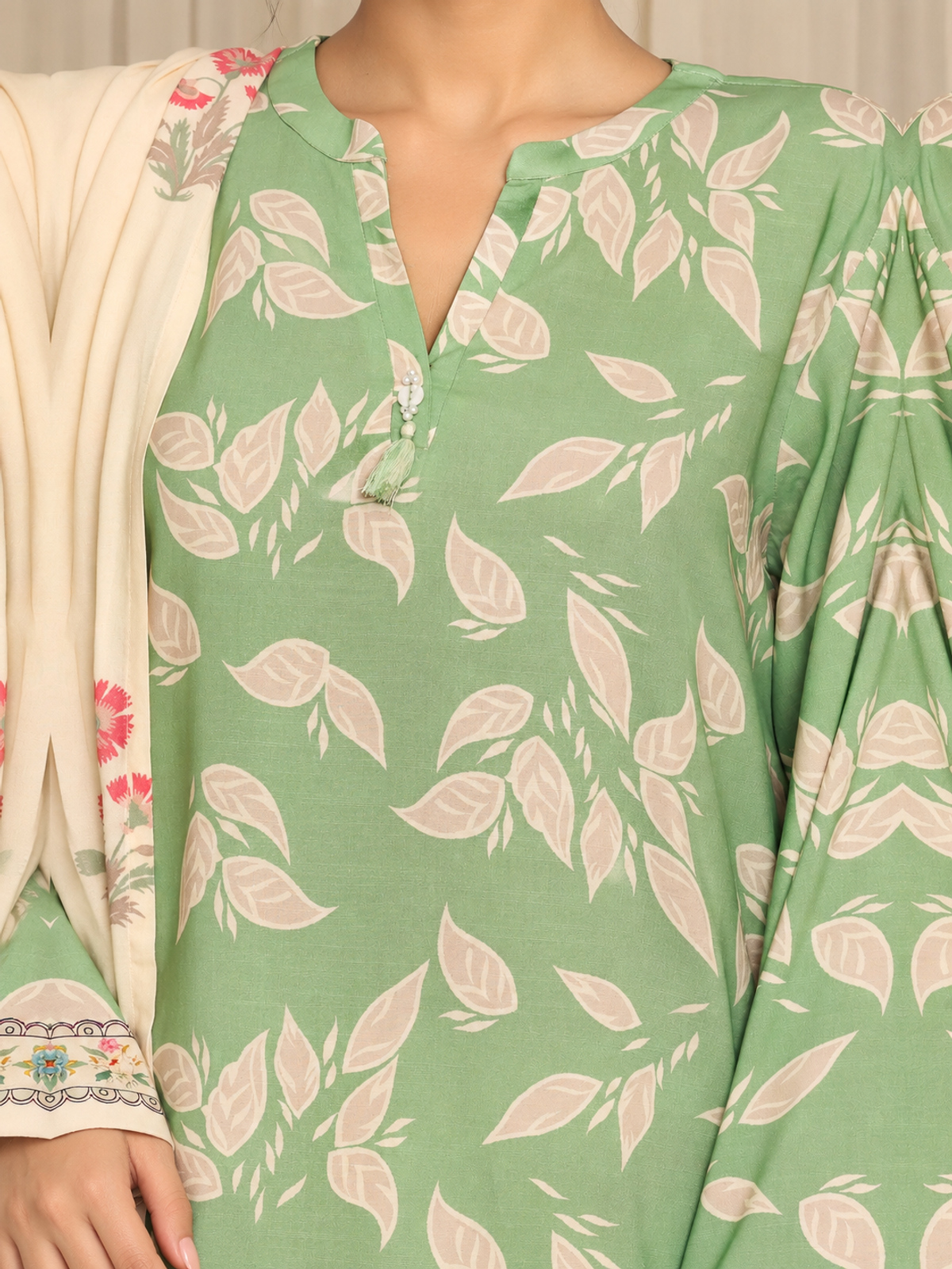 A sage-green shirt with pale botanical motifs, cream floral trousers…