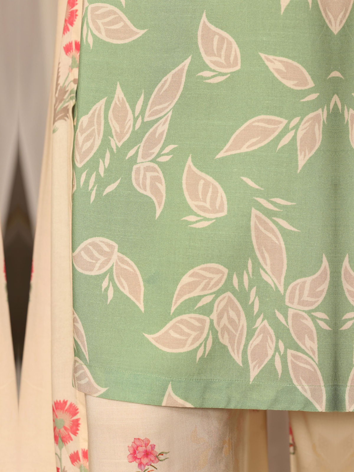 A sage-green shirt with pale botanical motifs, cream floral trousers…