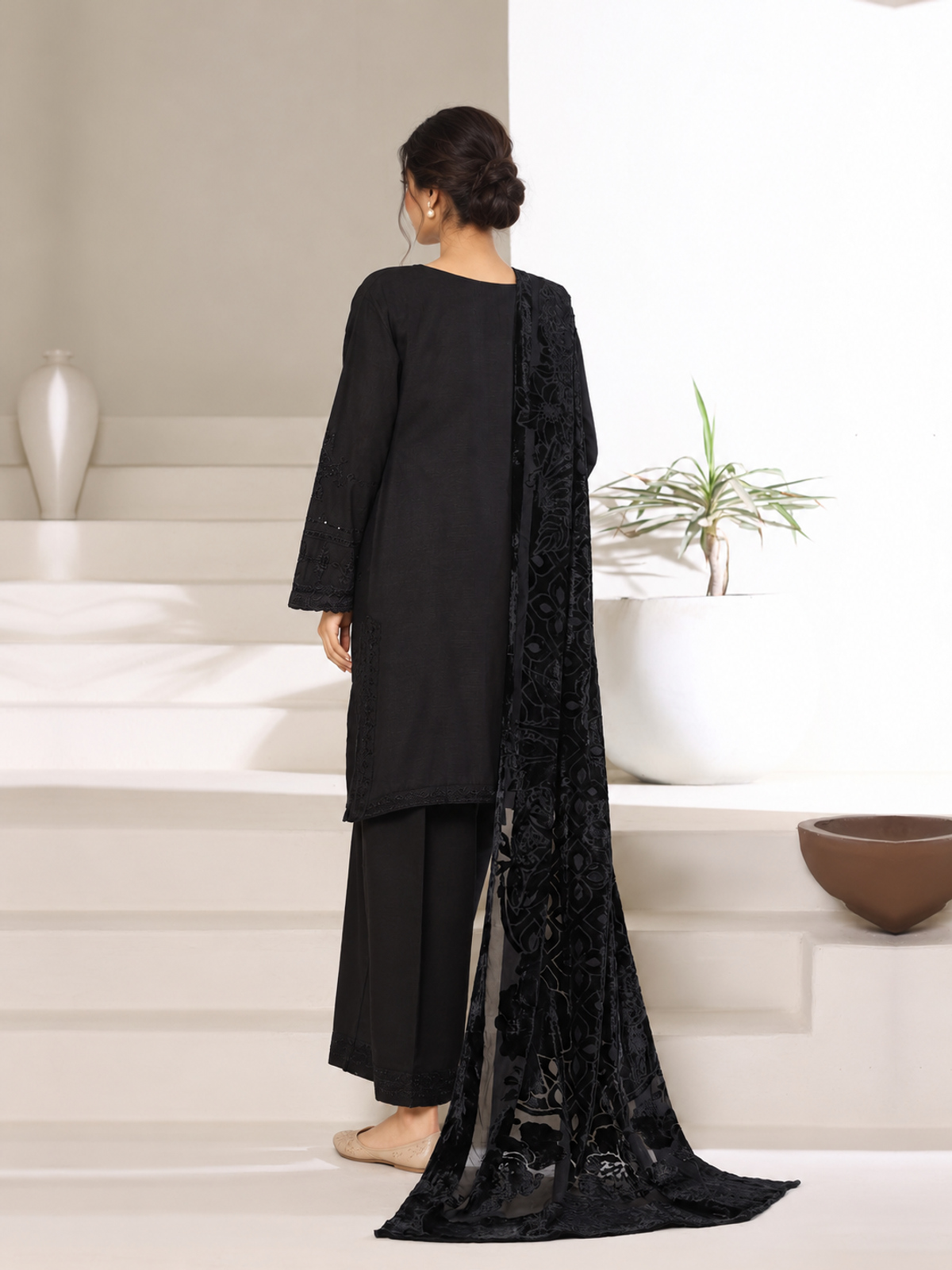 A black ensemble with tonal embroidery, matching trousers and a black…