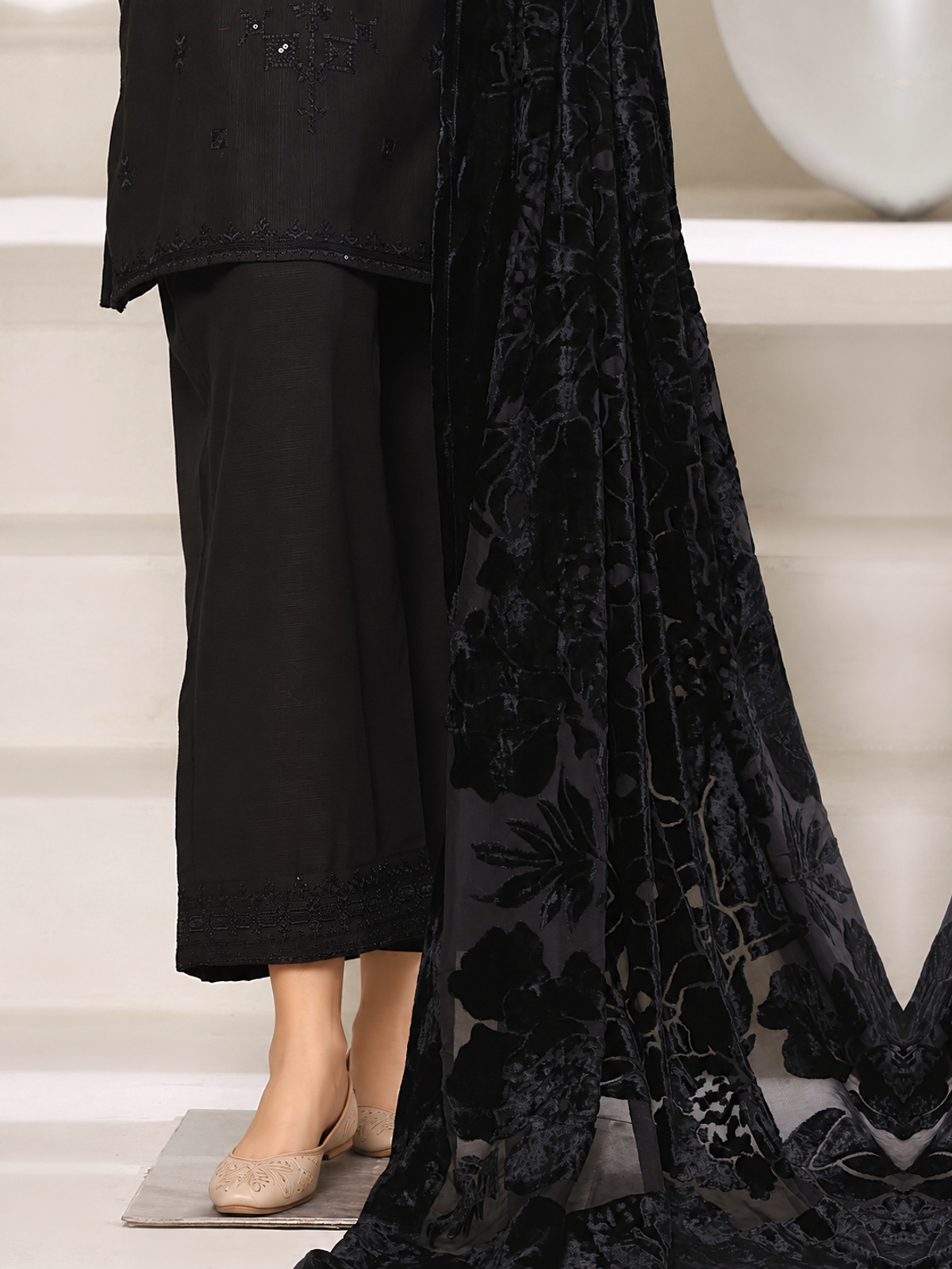 A black ensemble with tonal embroidery, matching trousers and a black…