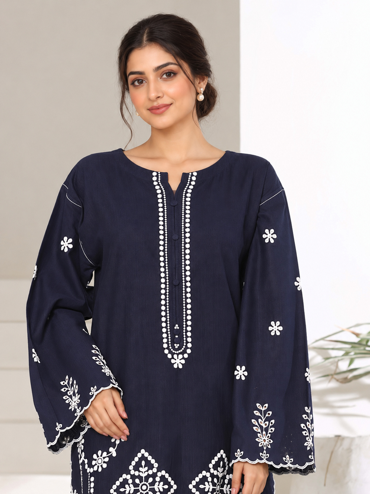 A navy ensemble with contrasting pale embroidery, matching trousers…