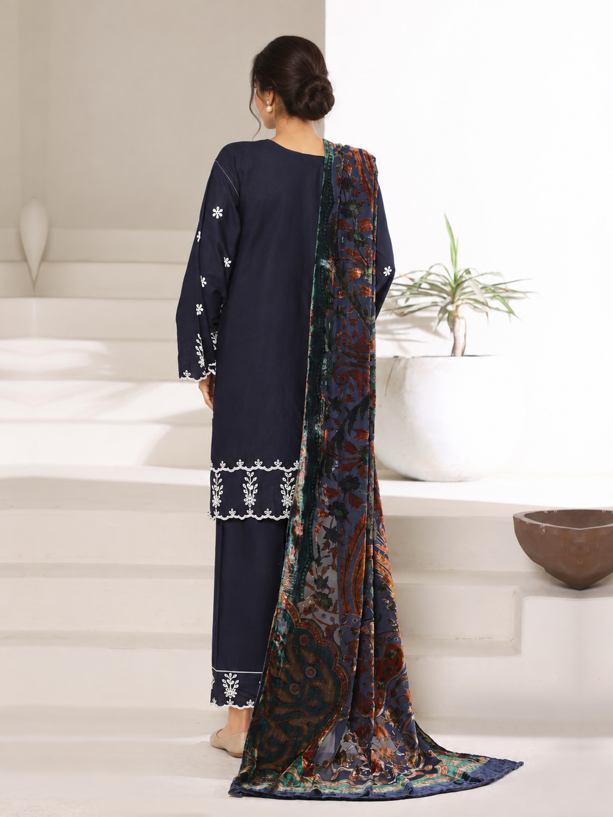 A navy ensemble with contrasting pale embroidery, matching trousers…
