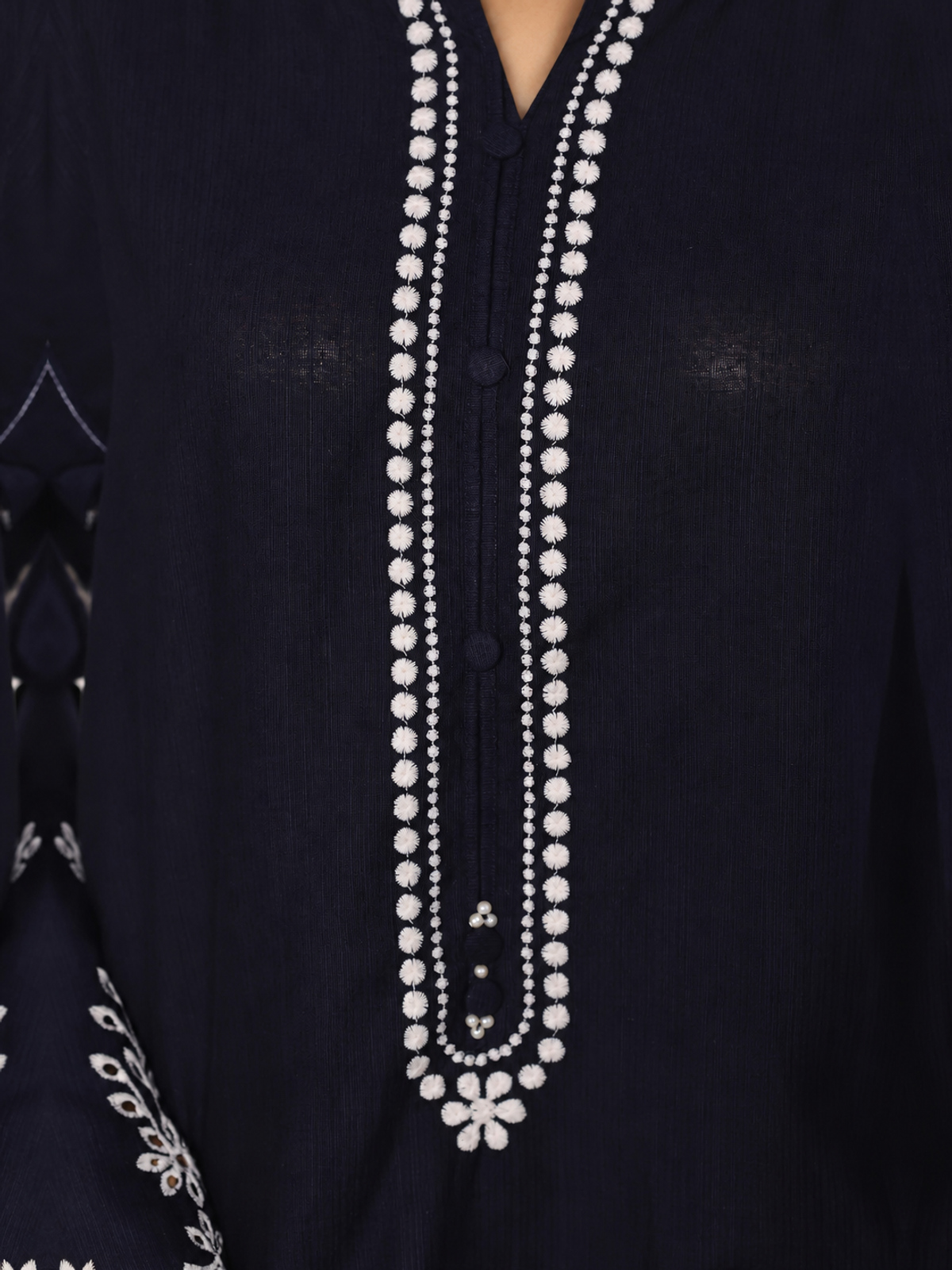 A navy ensemble with contrasting pale embroidery, matching trousers…