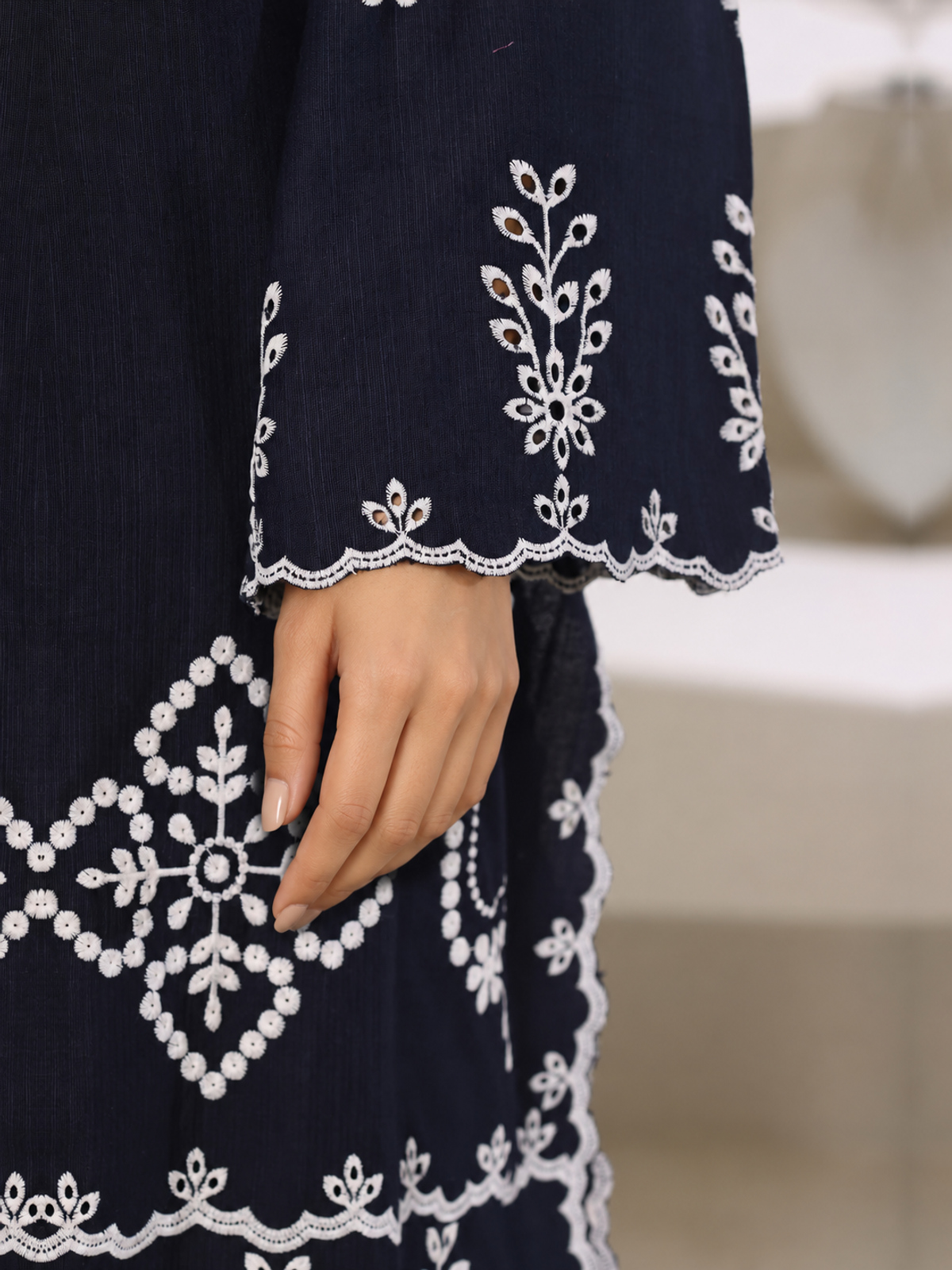 A navy ensemble with contrasting pale embroidery, matching trousers…