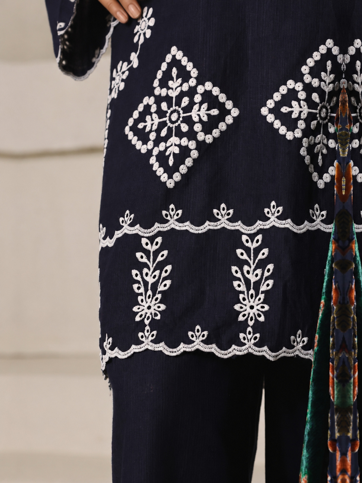 A navy ensemble with contrasting pale embroidery, matching trousers…