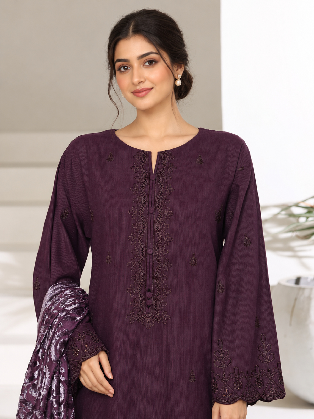 A plum ensemble with tonal floral embroidery, matching trousers and a…