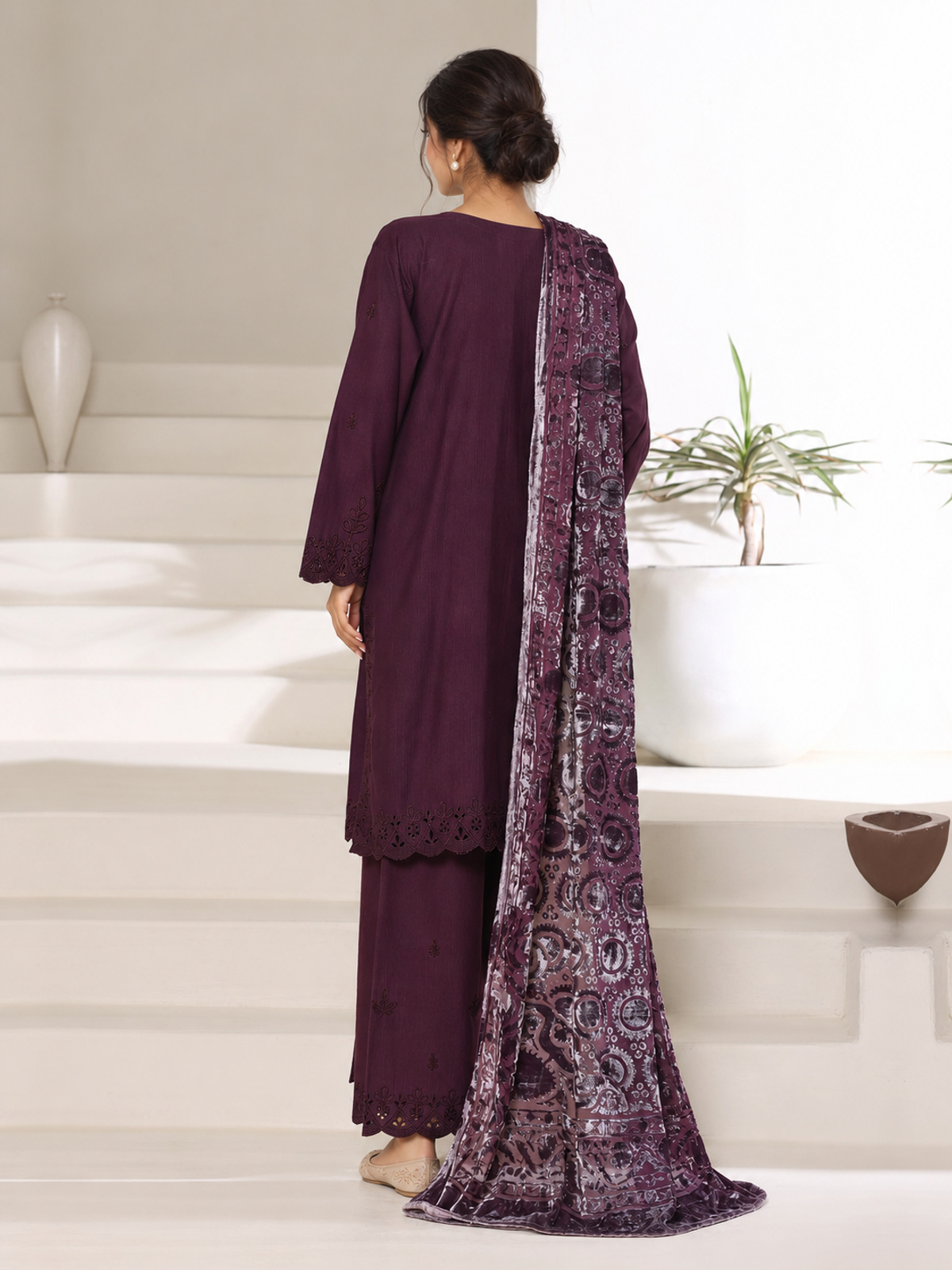 A plum ensemble with tonal floral embroidery, matching trousers and a…
