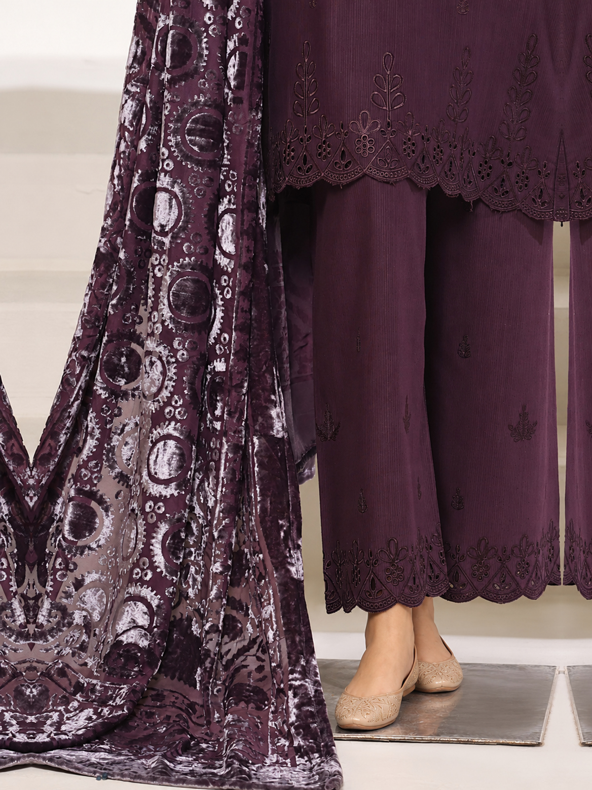 A plum ensemble with tonal floral embroidery, matching trousers and a…