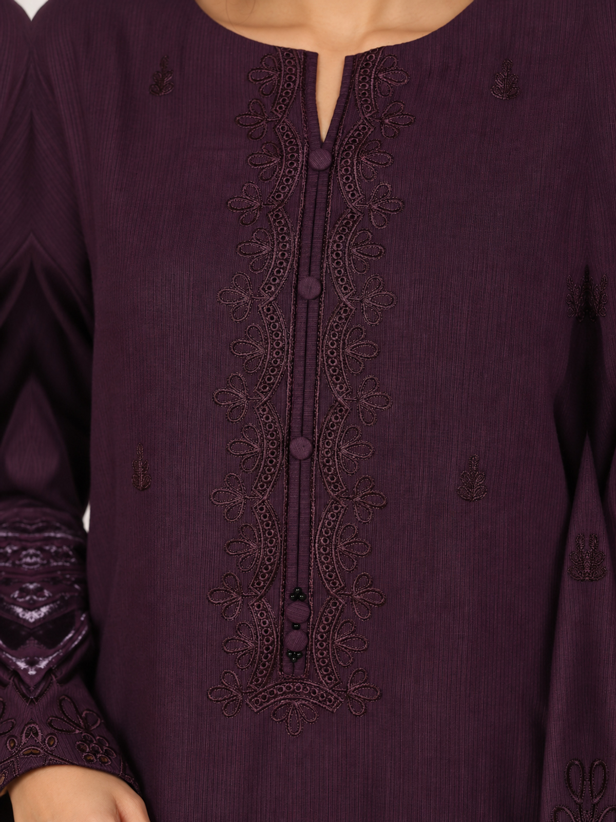 A plum ensemble with tonal floral embroidery, matching trousers and a…