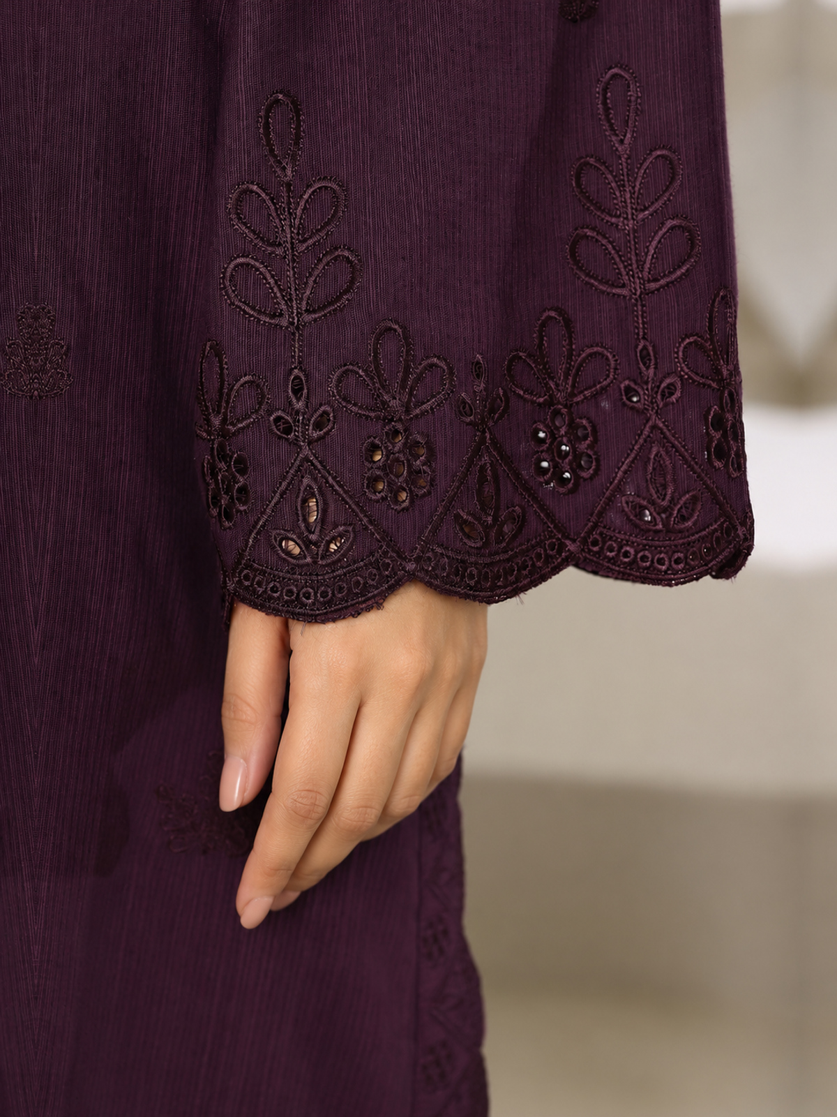 A plum ensemble with tonal floral embroidery, matching trousers and a…