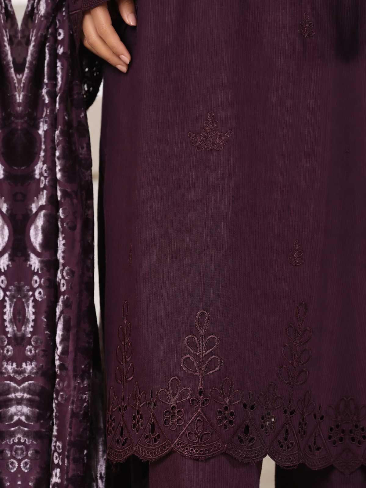 A plum ensemble with tonal floral embroidery, matching trousers and a…