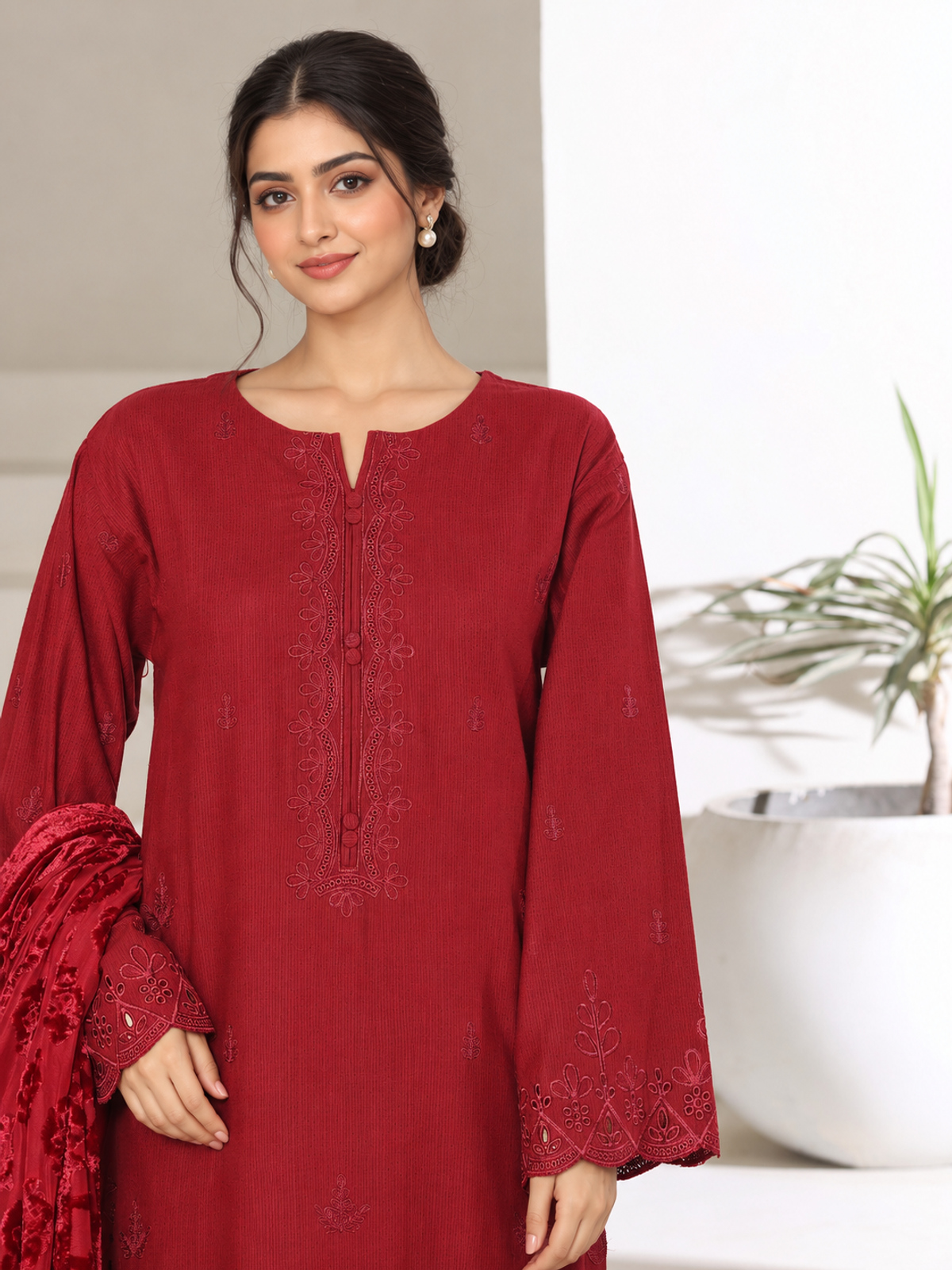 A deep-red ensemble with tonal floral embroidery, matching trousers…