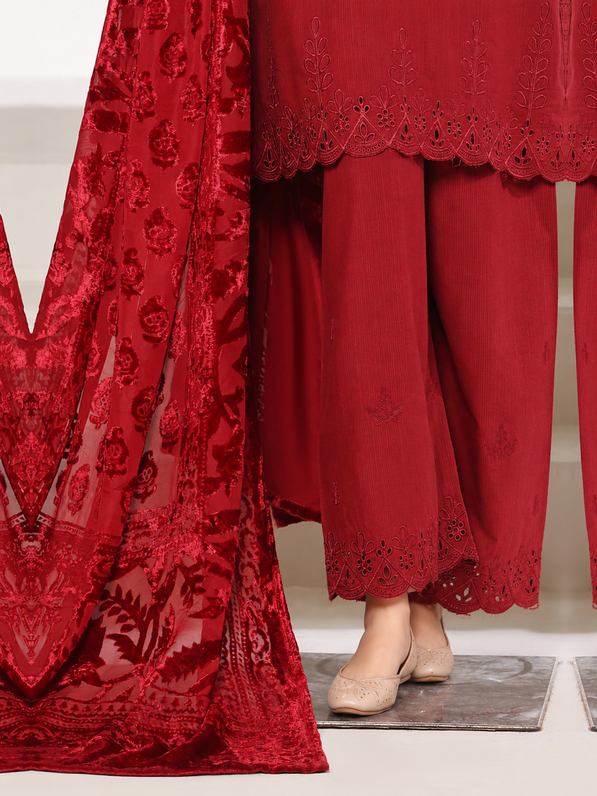 A deep-red ensemble with tonal floral embroidery, matching trousers…