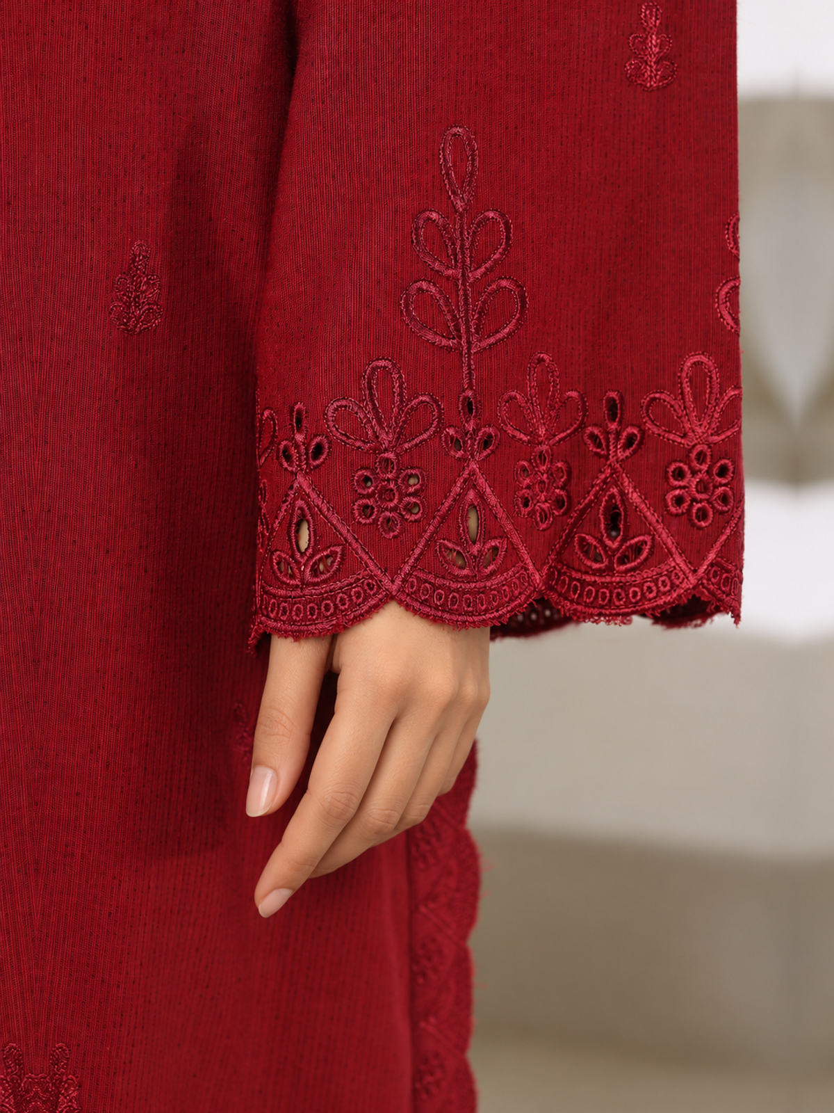 A deep-red ensemble with tonal floral embroidery, matching trousers…