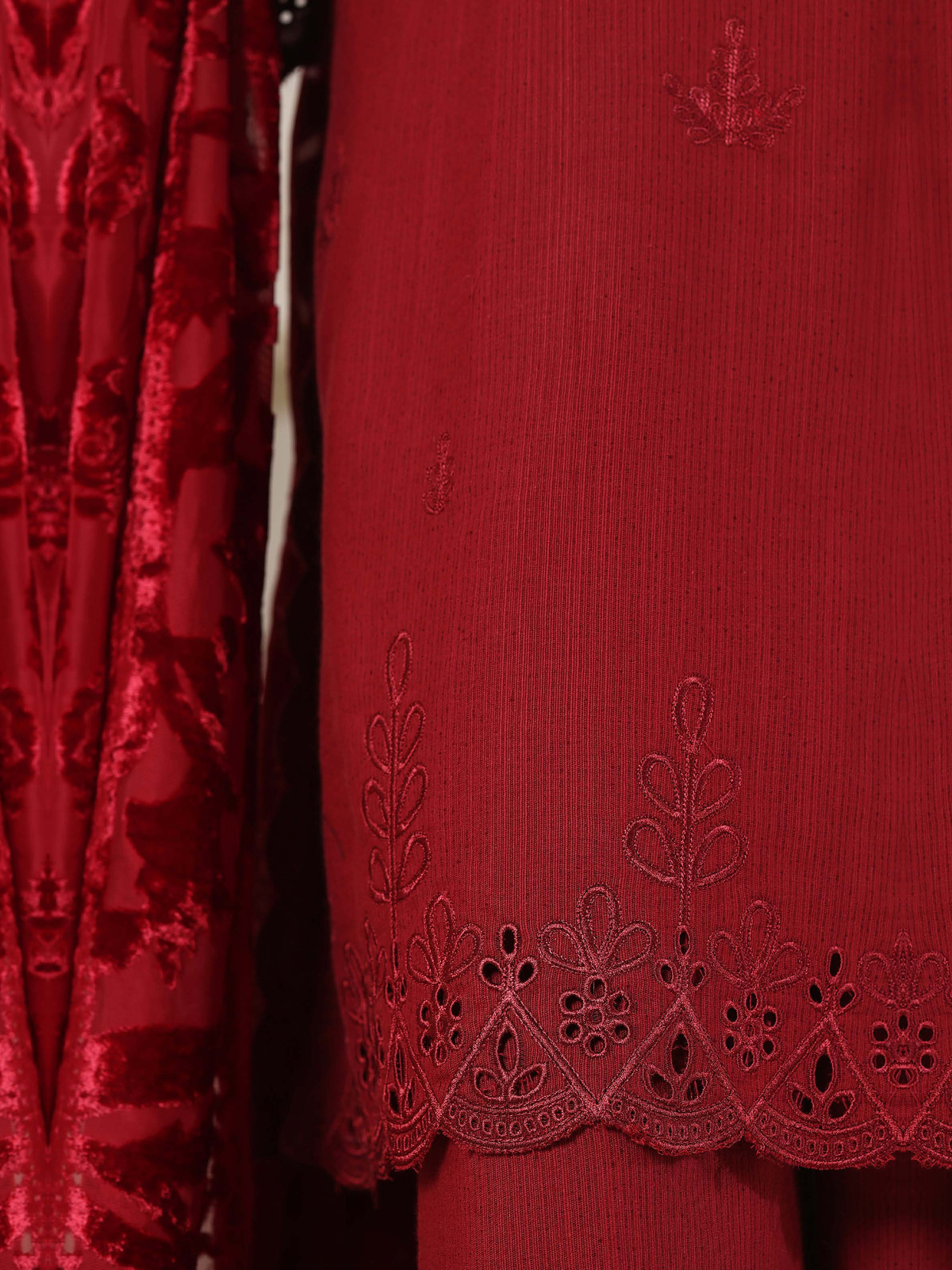 A deep-red ensemble with tonal floral embroidery, matching trousers…